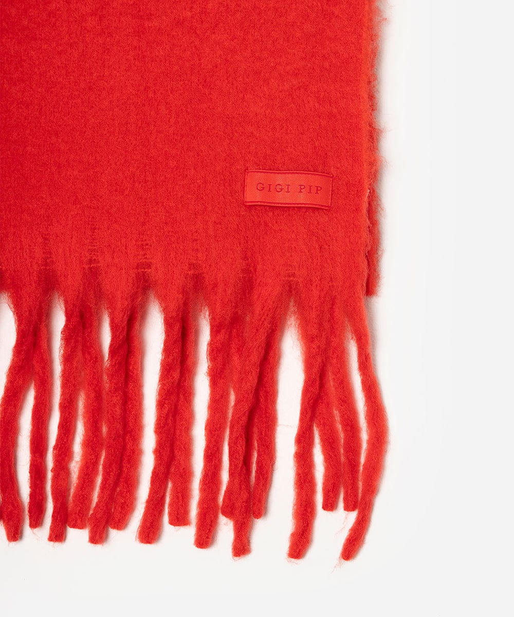 Red scarf with fringes and a brand label on a white background #color_red