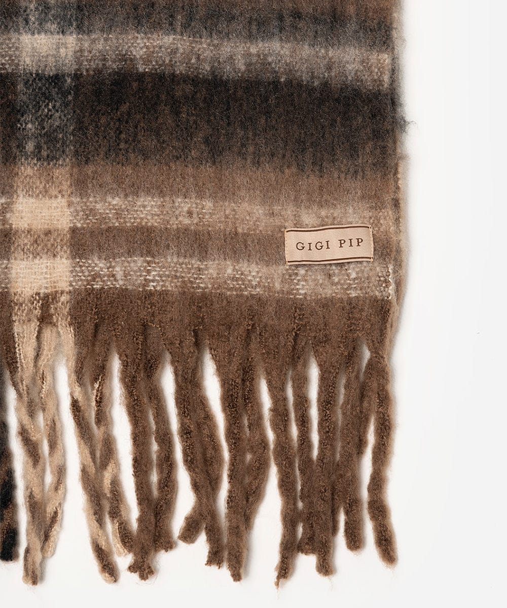 Brown plaid scarf with fringes and 'Gigi Pip' label on a white background #color_Brown - Black Plaid
