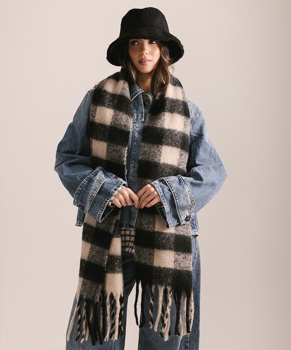 Person wearing a checkered scarf, denim jacket, and black hat on a plain background #color_Black - Cream Buffalo Check