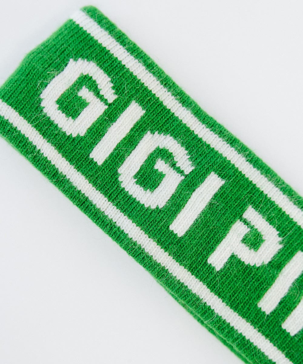 Close up image of an evergreen colored headband with 'GIGI PIP' text on a white background #color_evergreen