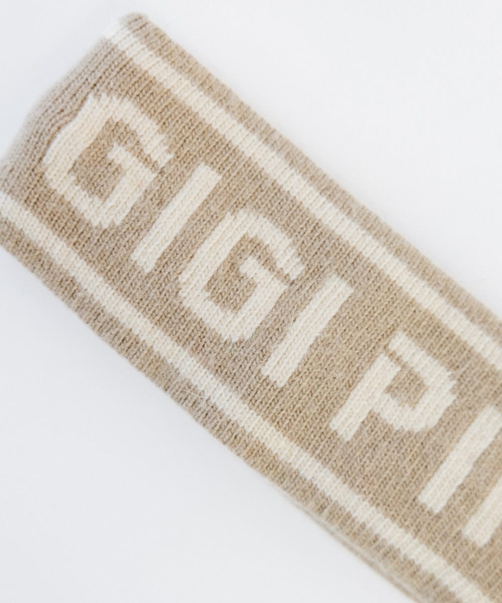 Close up image of a taupe colored headband with 'GIGI PIP' text on a white background #color_taupe