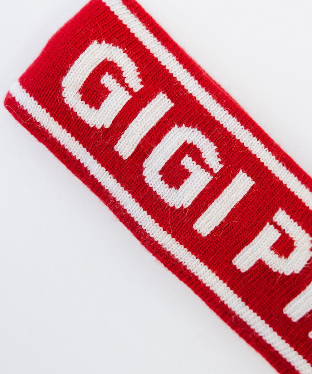 Close up image of a ruby red colored headband with 'GIGI PIP' text on a white background #color_ruby red