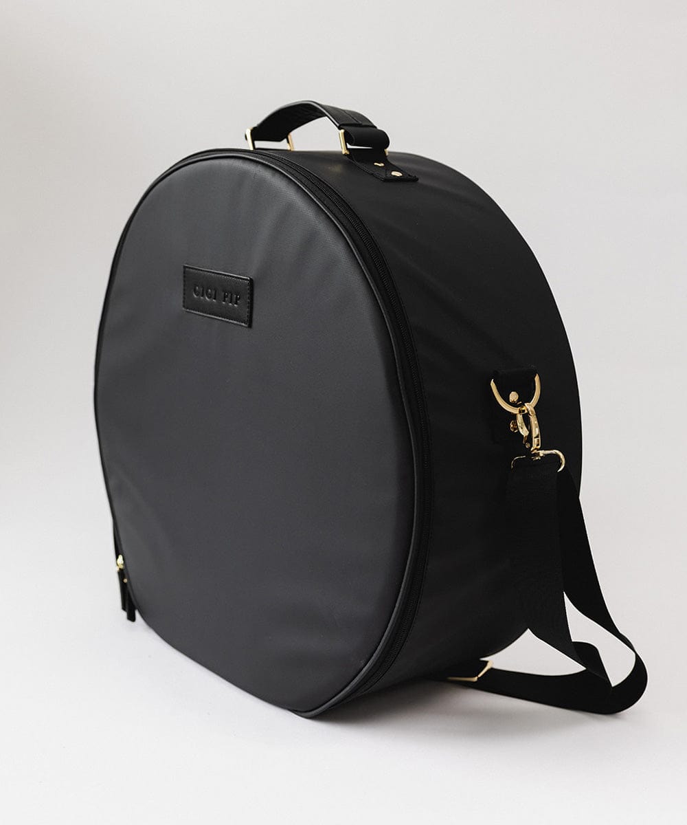 A black round hat travel case with a handle at the top against a plain background #color_black