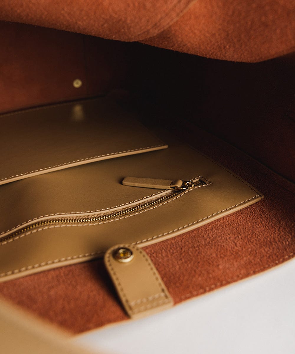 The inside pocket of a tan Dia Everyday Leather Tote Bag #color_tan