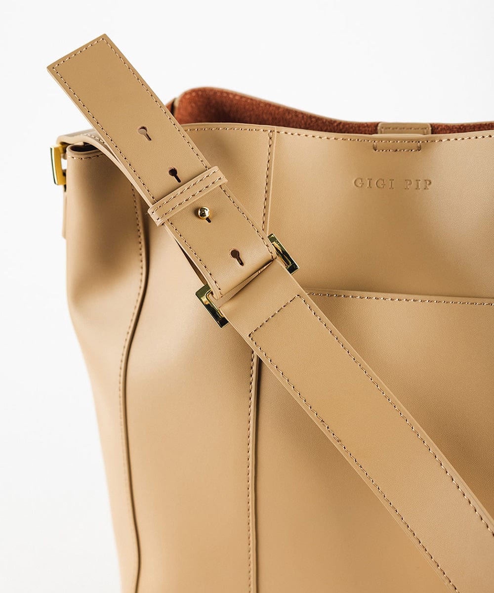 Close up image of a tan Dia Everyday Leather Tote Bag against a plain background #color_tan