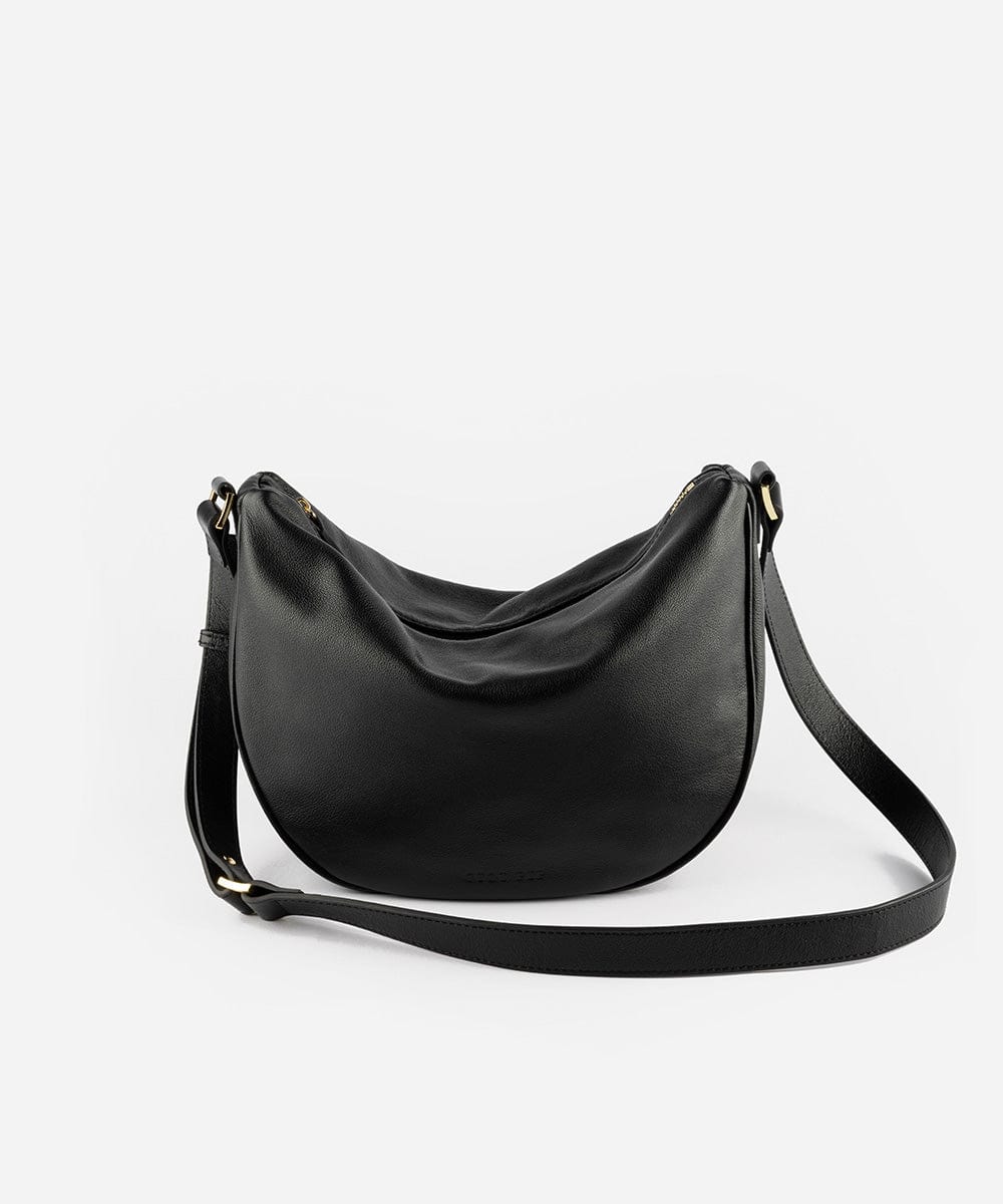 A black genuine leather slouchy bag with a shoulder strap and zipper closure #color_black