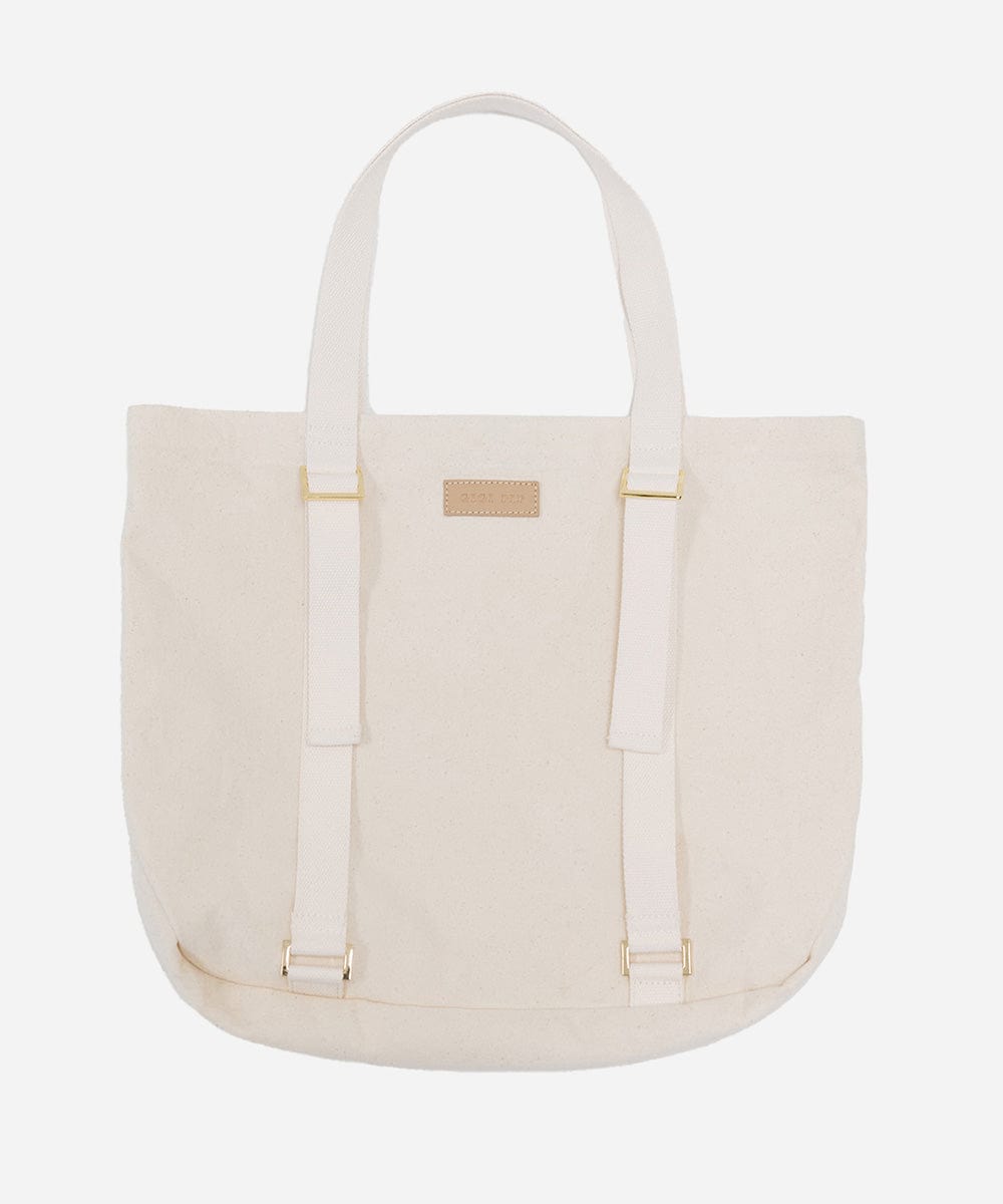 A natural colored canvas tote bag with two adjustable straps designed to carry a hat. #color_natural