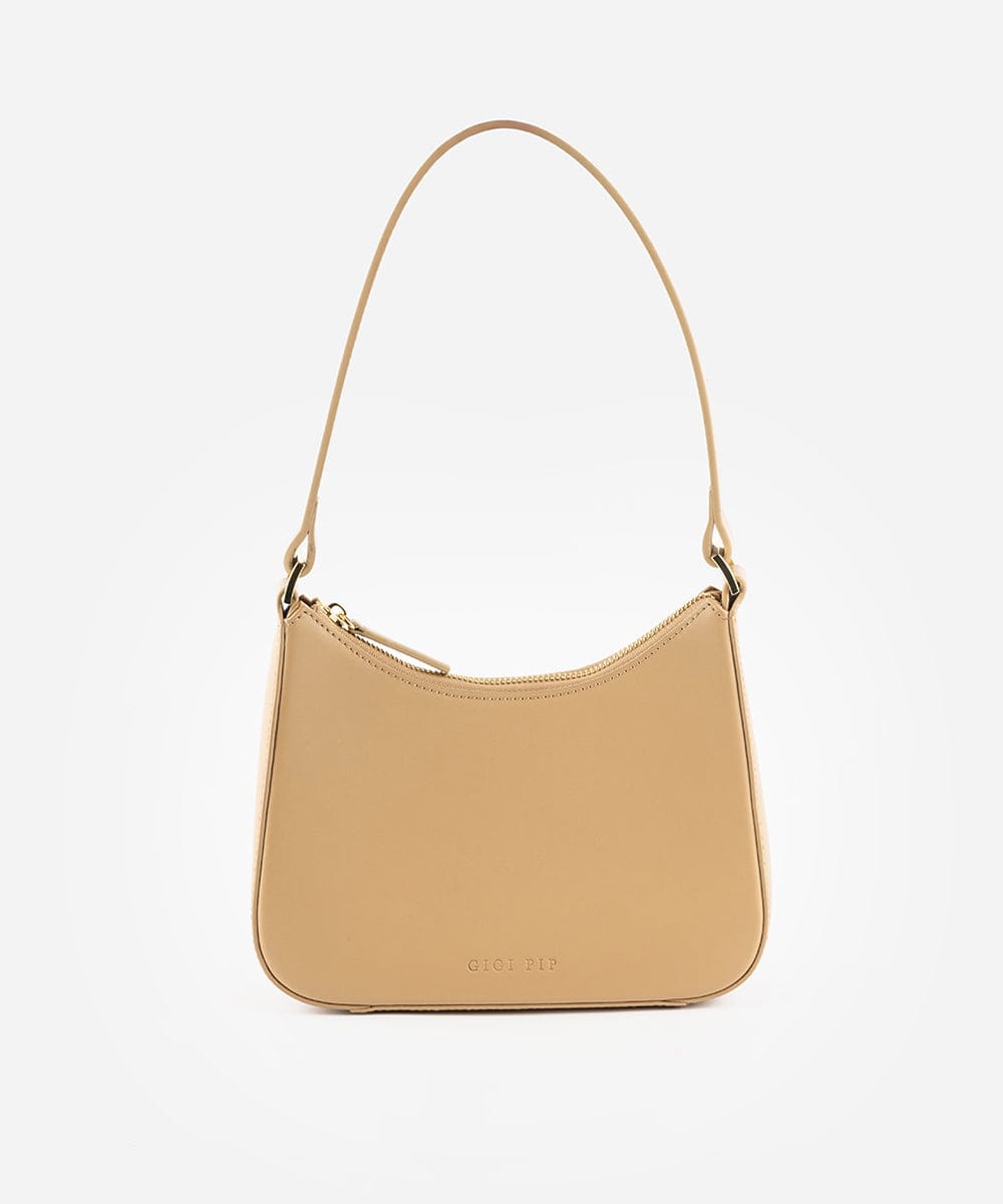 A tan genuine leather handbag with a shoulder strap against a plain background #color_tan