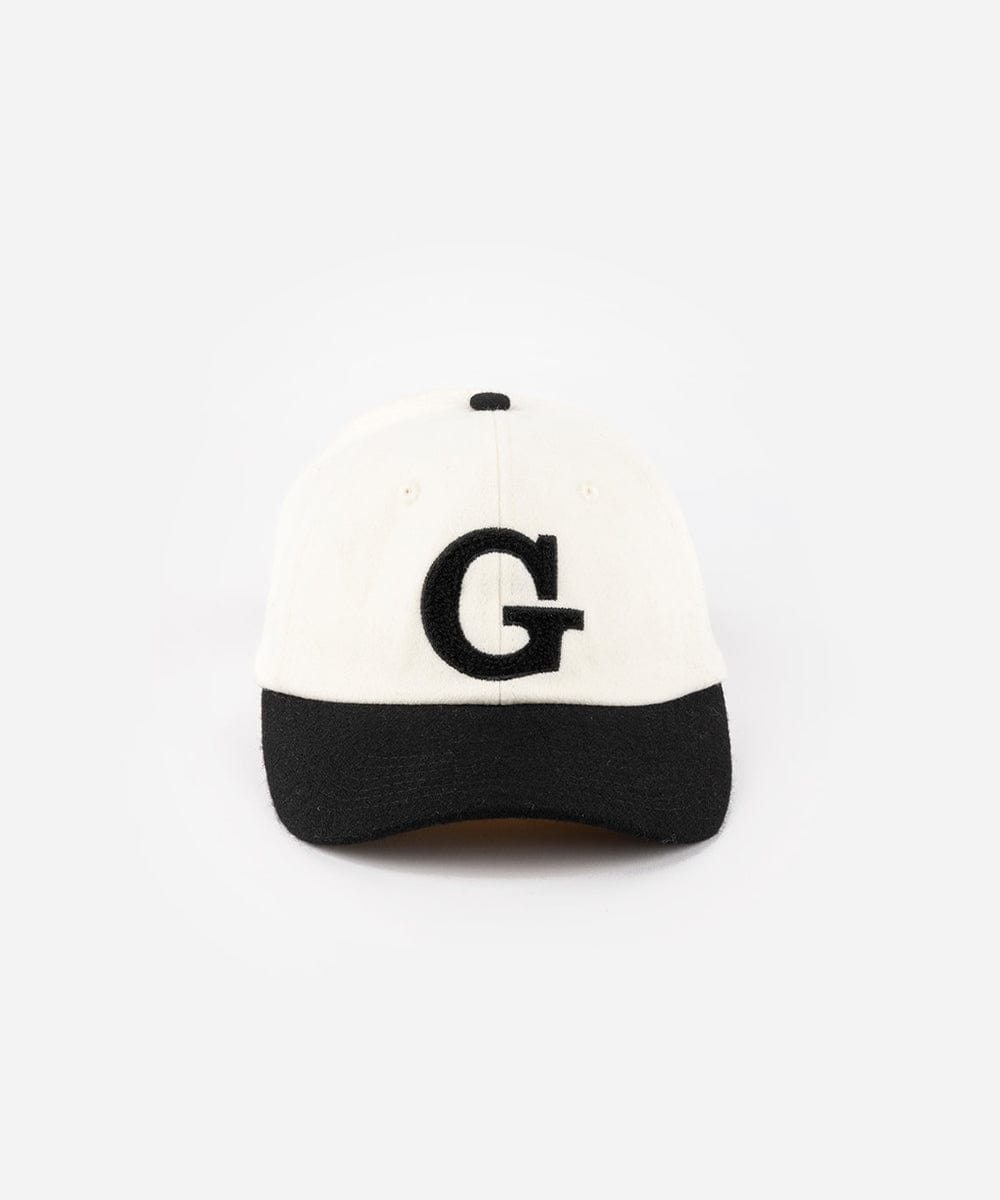 A cream and black baseball cap with the letter 'G' on a white background #color_cream-black