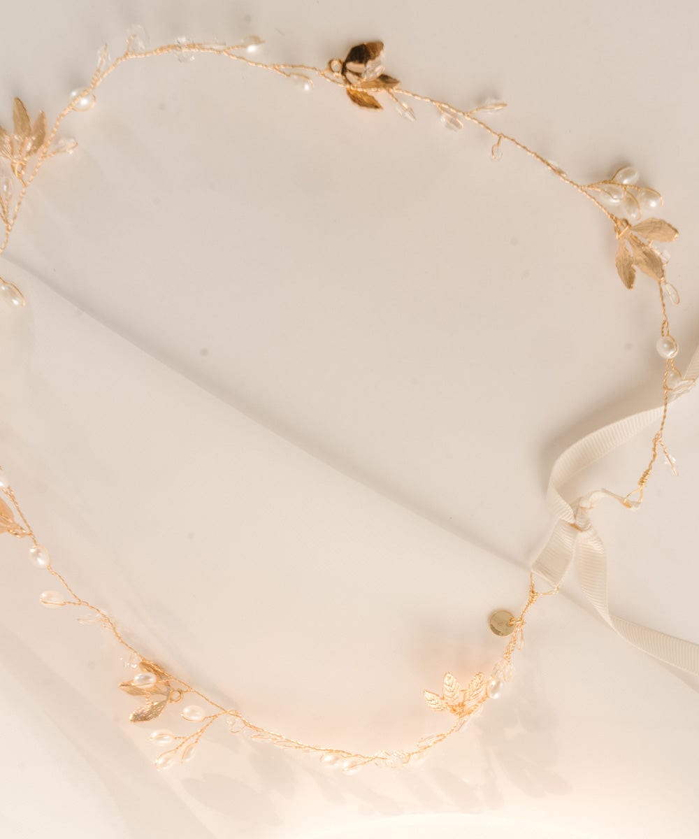 Delicate gold floral hat band on a plain background #color_gold