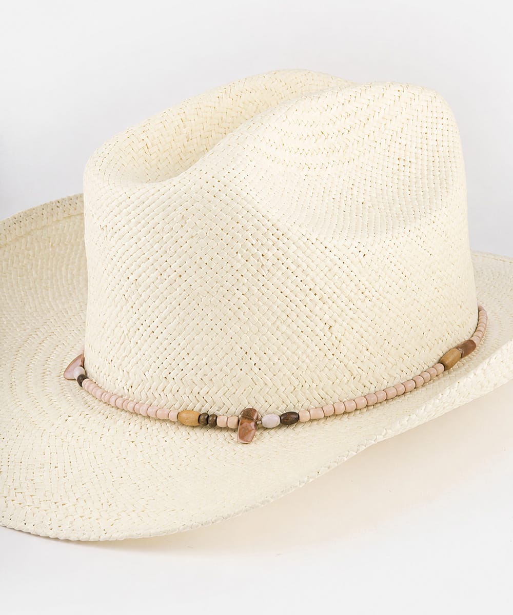 Beige straw hat with a decorative band on a plain background #color_natural