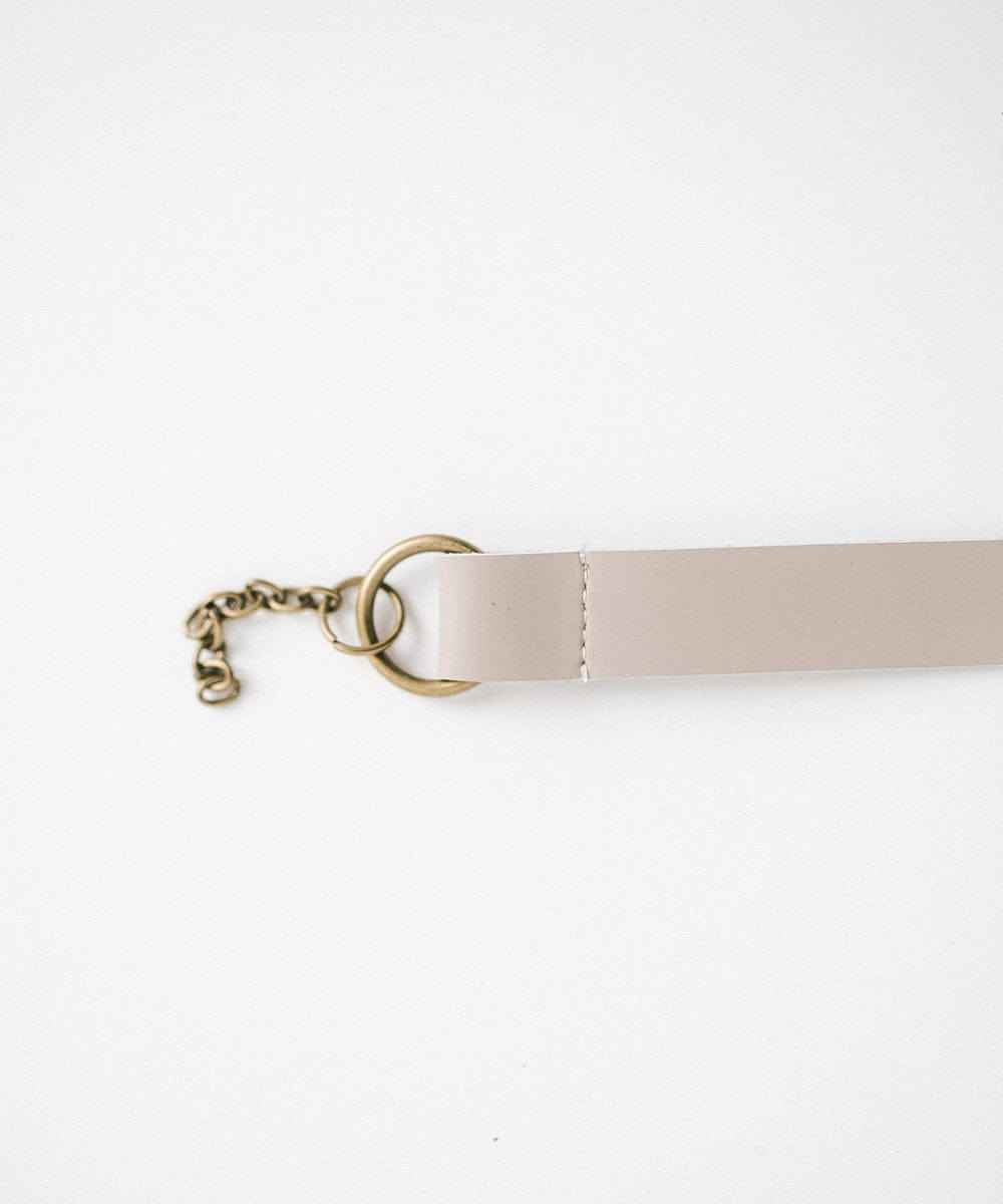 A stone colored leather adjustable chain band on a white background #color_stone