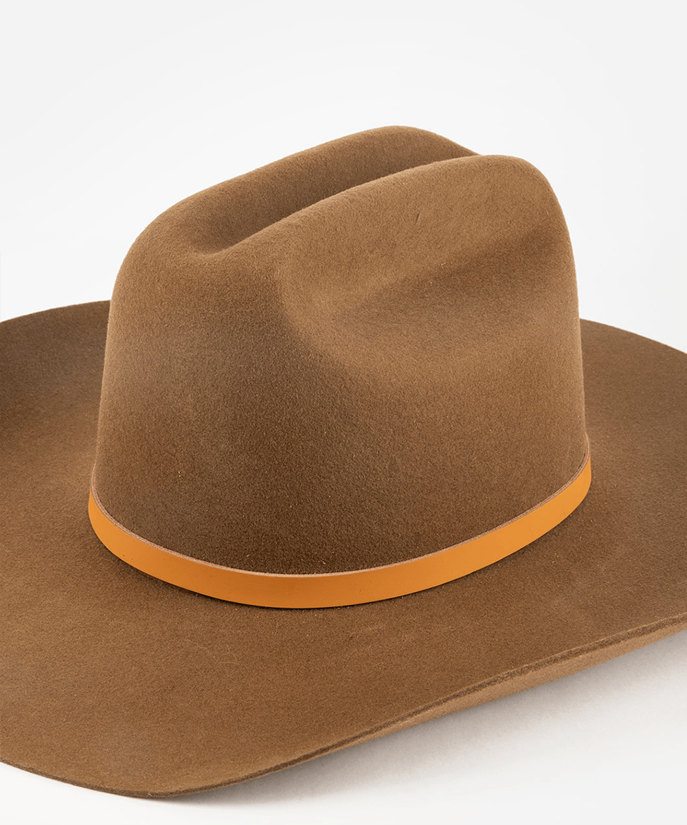 Brown cowboy hat with a cognac leather band on a white background #color_cognac