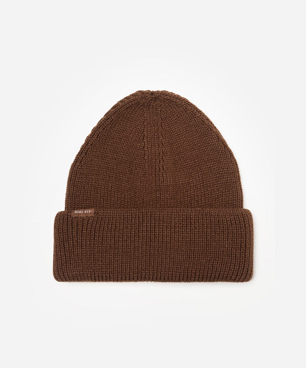 Brown knit beanie with a brand label on a light gray background #color_chocolate