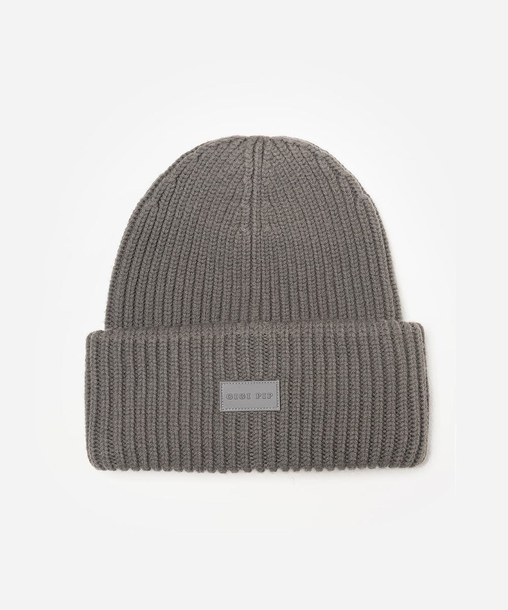 Grey knit beanie with a label on a white background #color_grey