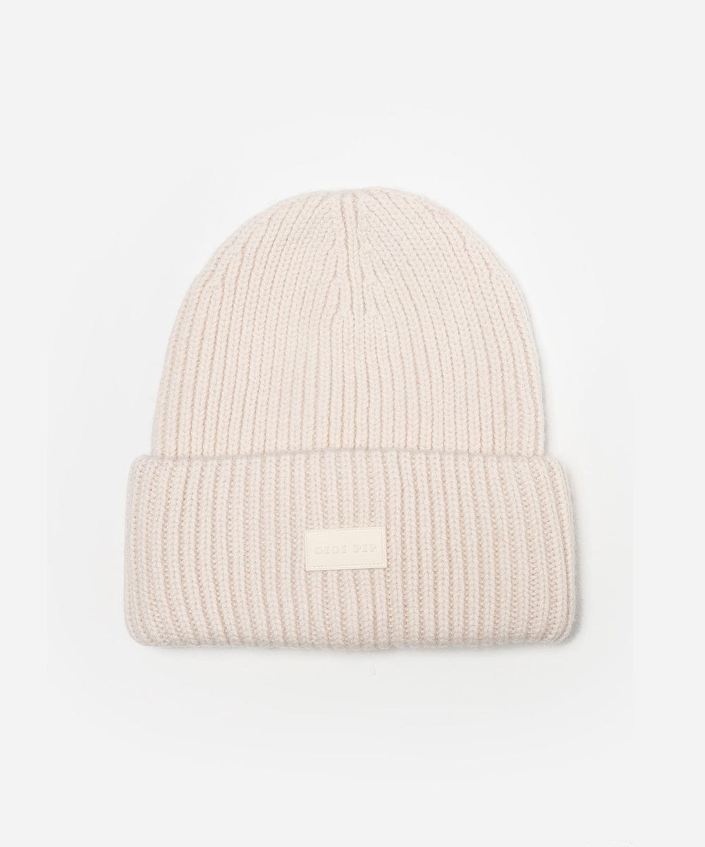 Off white knit beanie with a logo patch on a light gray background #color_off white