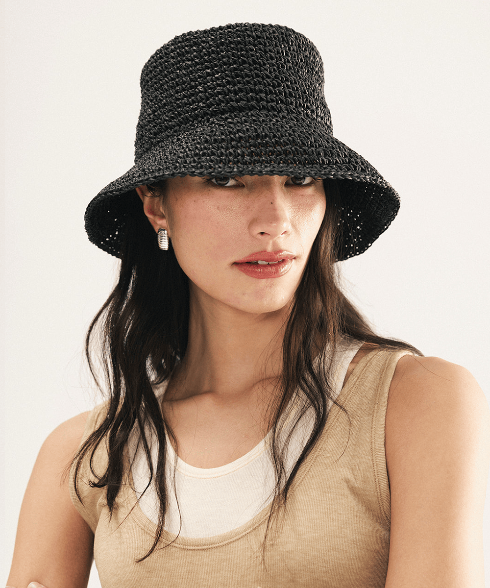 Woman wearing a black woven bucket hat on a white background
#color_black