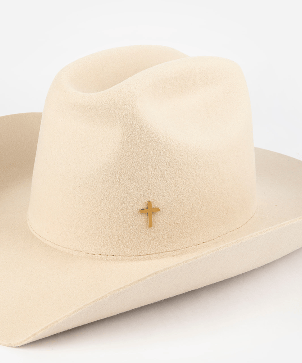 Pink cowboy hat with a gold cross-shaped hat pin on a white background #color_gold
