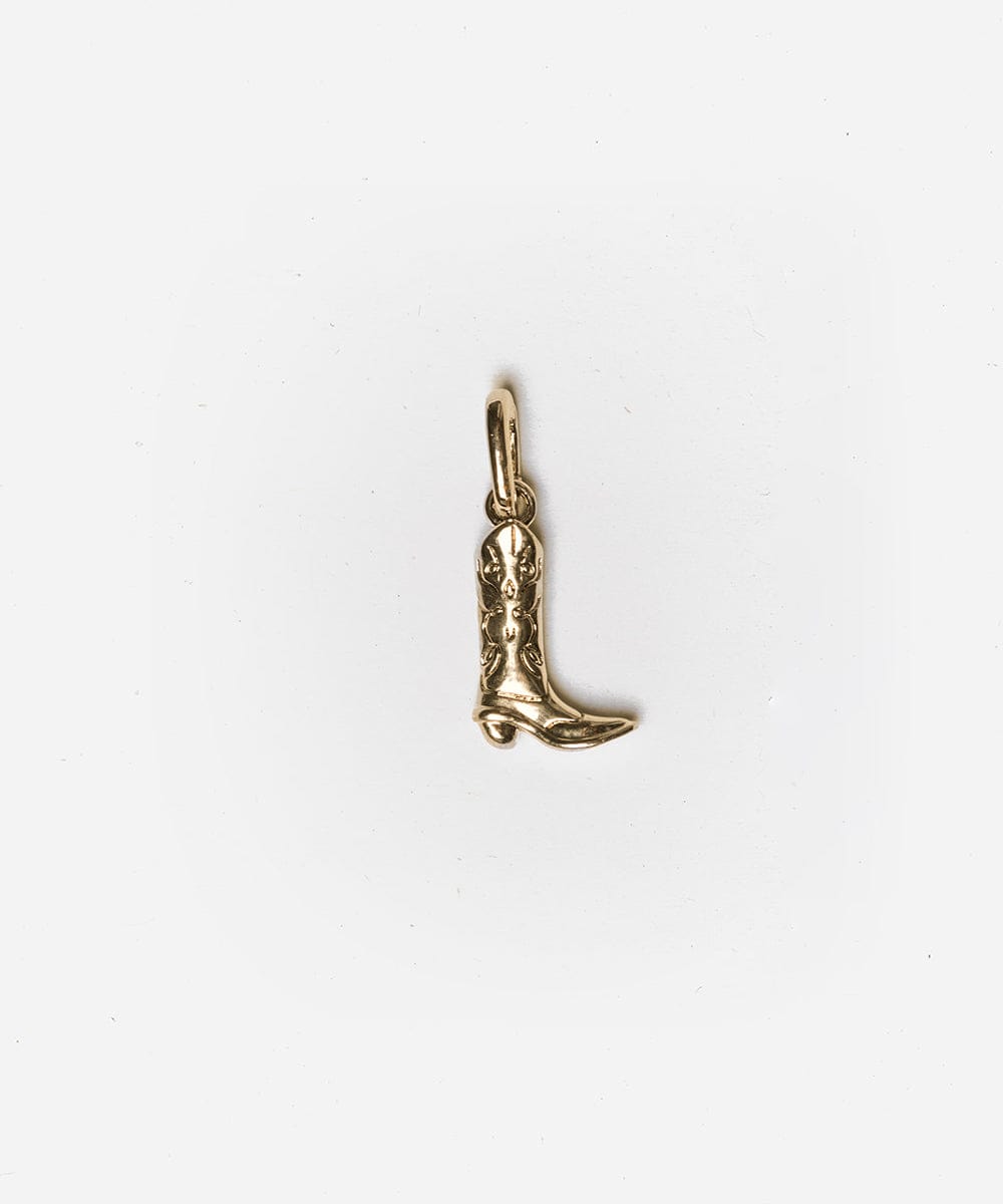 A gold cowboy boot hat charm on a white background #color_gold