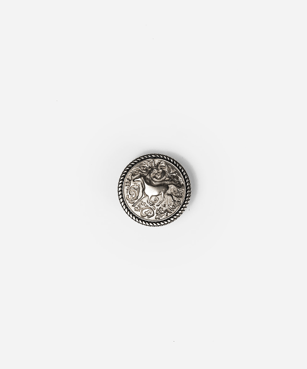 A single round silver-toned decorative button with an embossed animal motif and rope-style border, centered on a plain light gray background #color_silver
