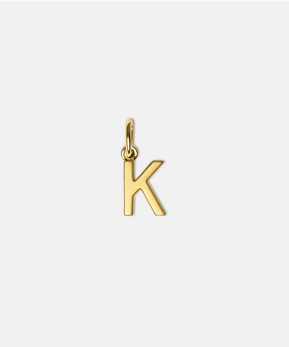 Gold letter 'K' hat charm on a white background #color_gold