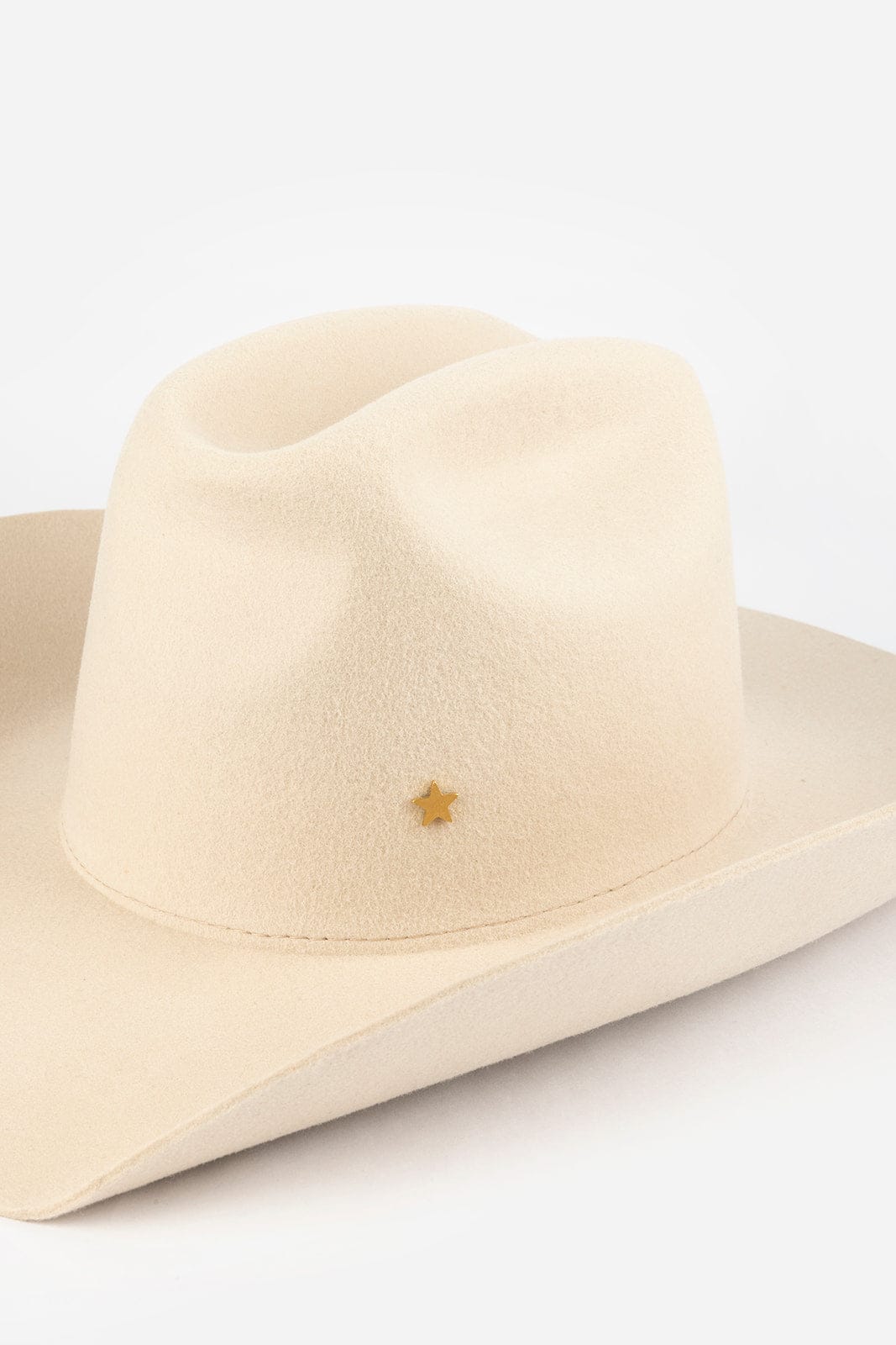 Pink cowboy hat with a gold star-shaped hat pin on a white background #color_gold