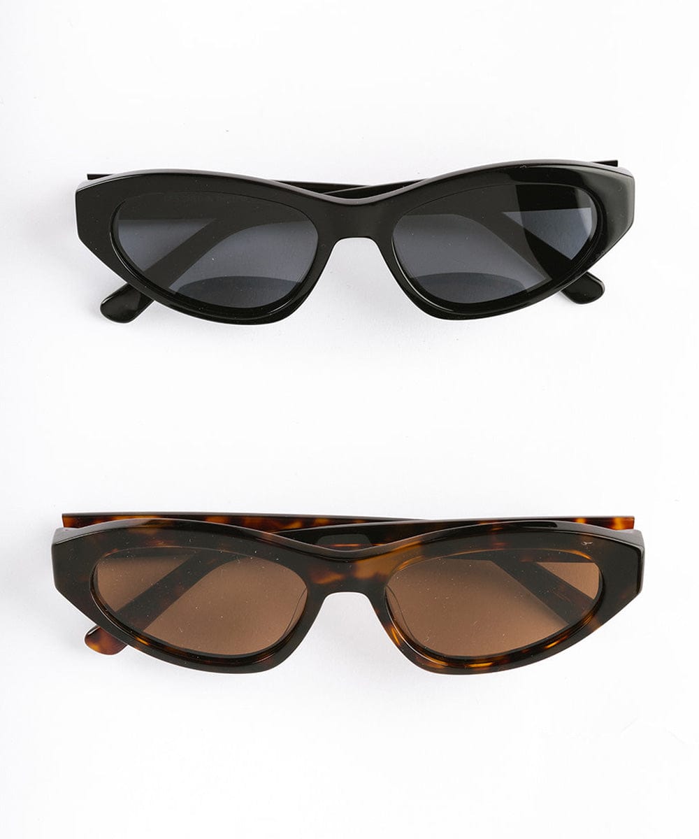 Black and tortoise colored cat eye sunglasses on a white background