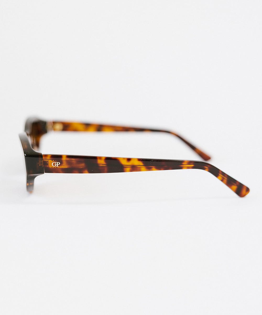 Side angle of a tortoise colored cat eye sunglasses on a white background #color_tortoise