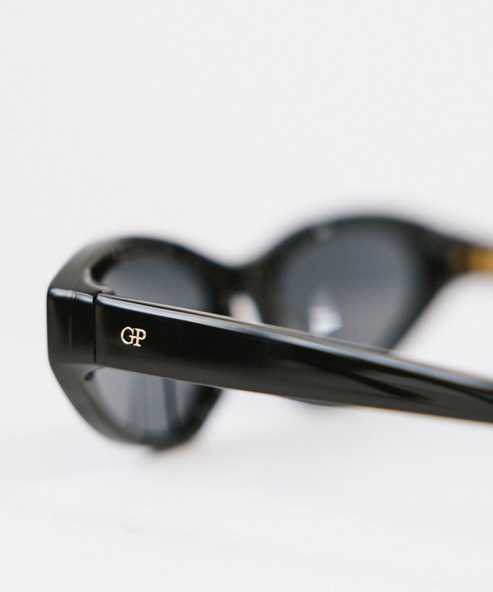 Side angle of a black colored cat eye sunglasses on a white background #color_black