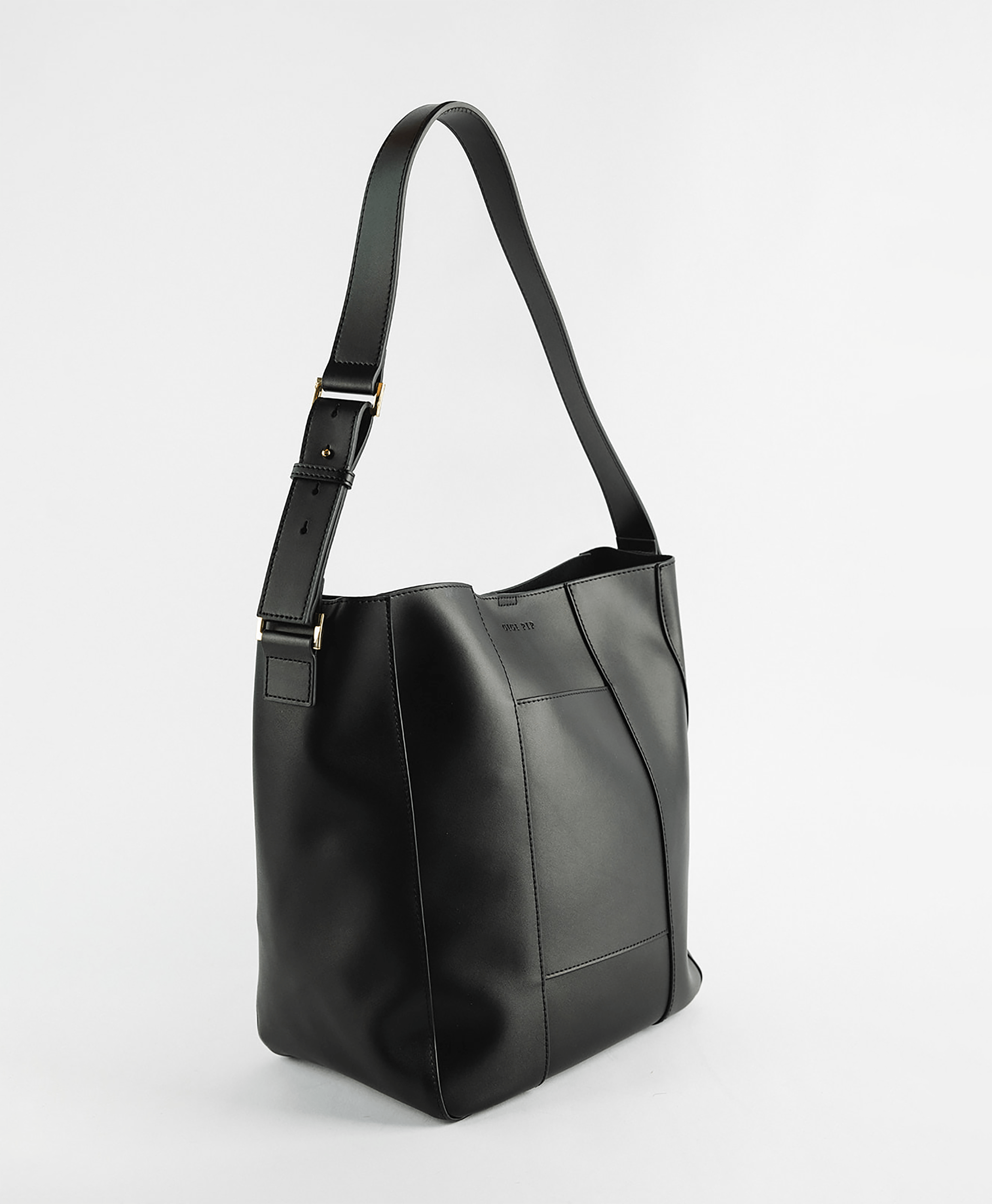 A black Dia everyday leather tote bag with an adjustable strap and a front pocket against a plain background #color_black
