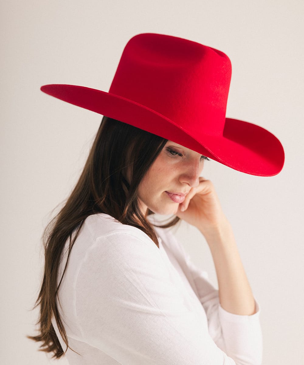 Woman wearing a red hat against a plain background #color_cherry red