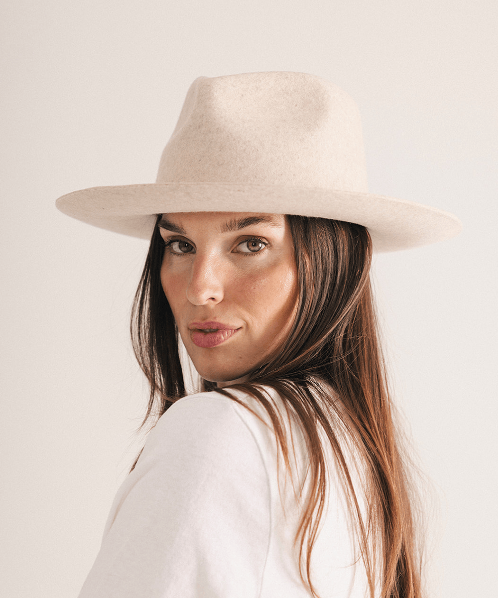 Woman wearing a beige fedora hat with a neutral background #color_mix ivory