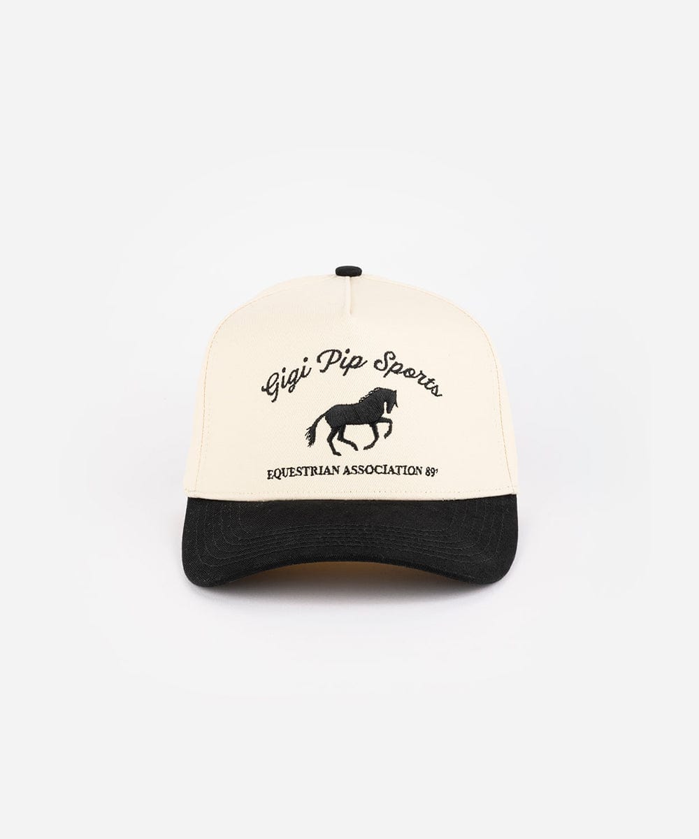 A cream and black Trucker hat with 'Gigi Pip Sports' and horse logo on a white background #color_cream - black