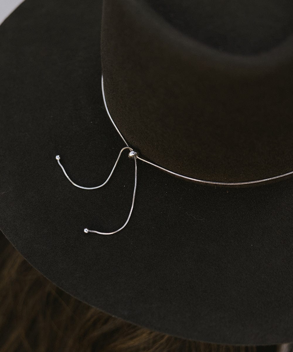A black hat with a silver chain bolo hat band #color_silver