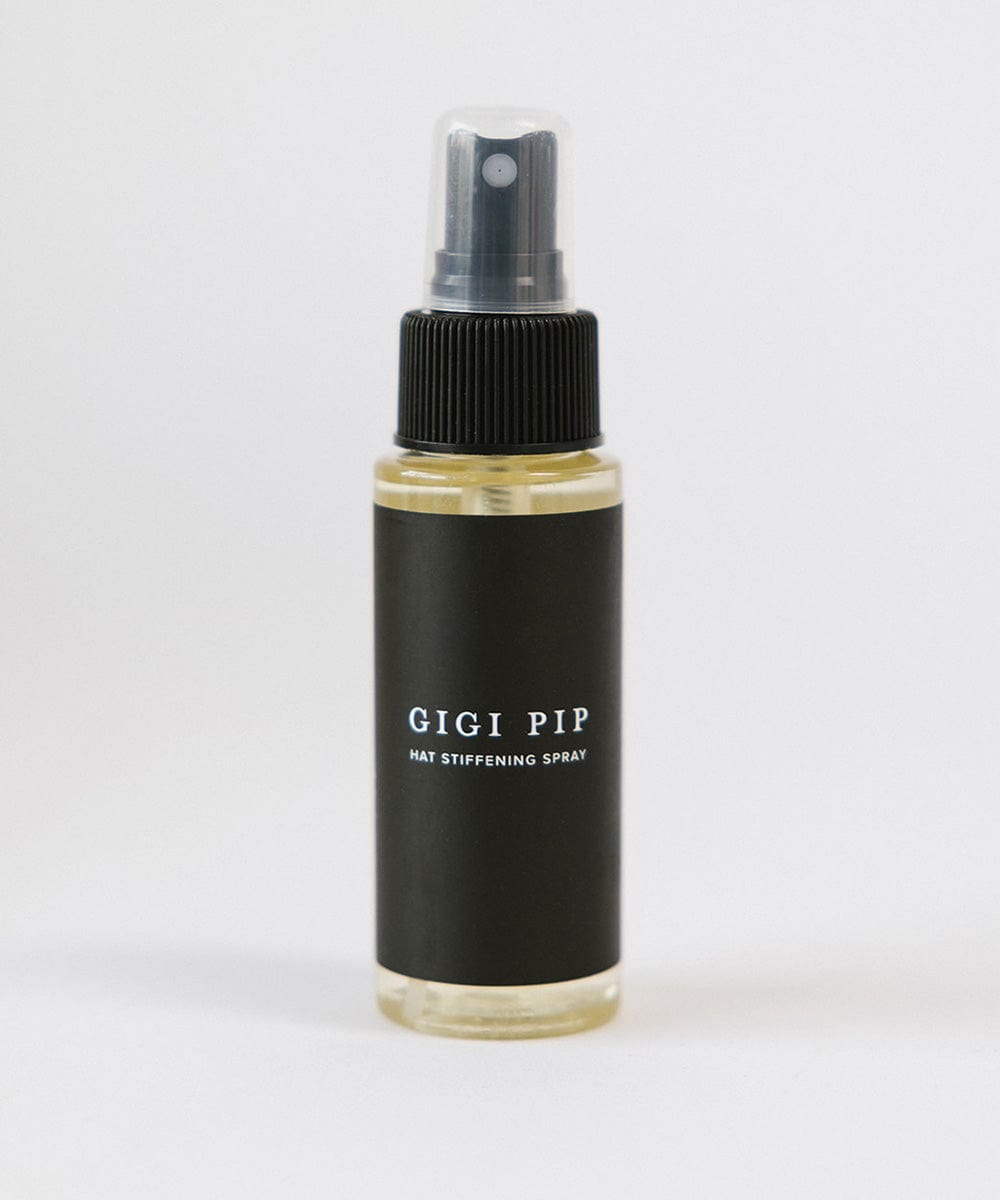 Black hat stiffener spray bottle labeled 'GIGI PIP' on a white background #color_natural