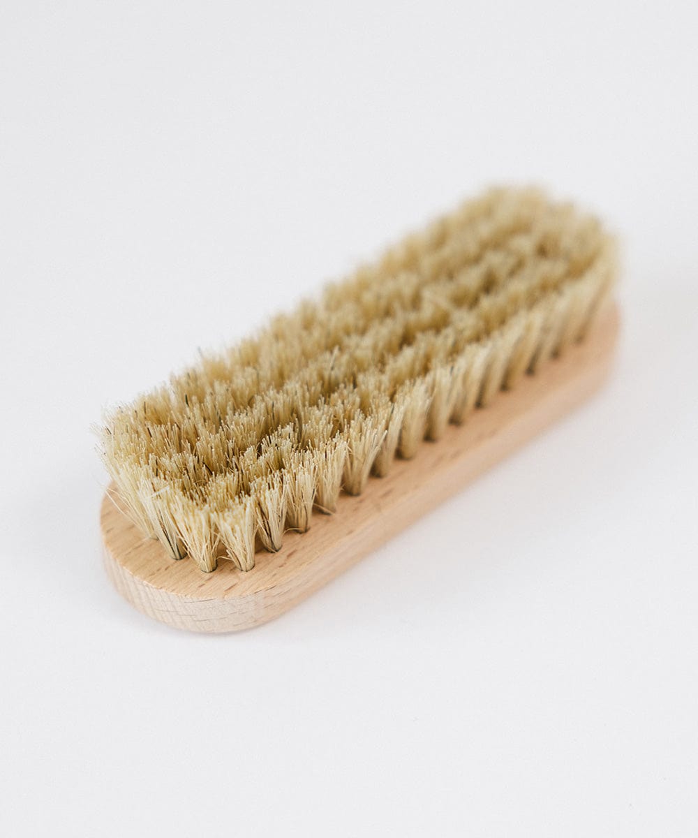 Close up image of a hat brush on a white background