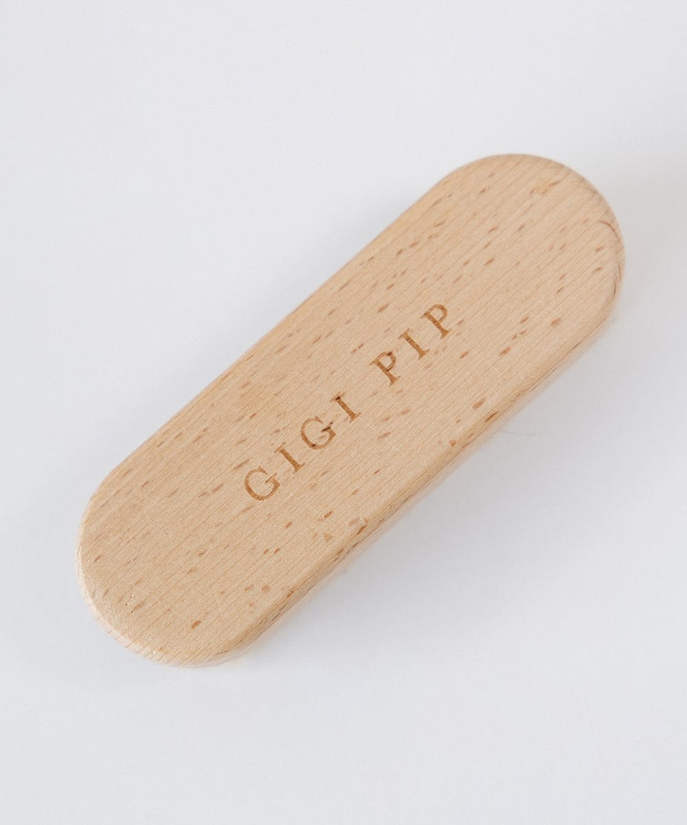 A cream colored hat brush with the text 'GIGI PIP' on a white background