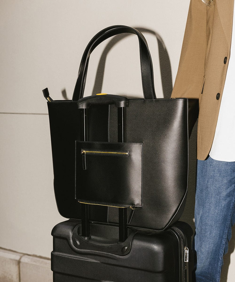 Black Hayes Hat Carrying Tote bag on a black suitcase #color_black