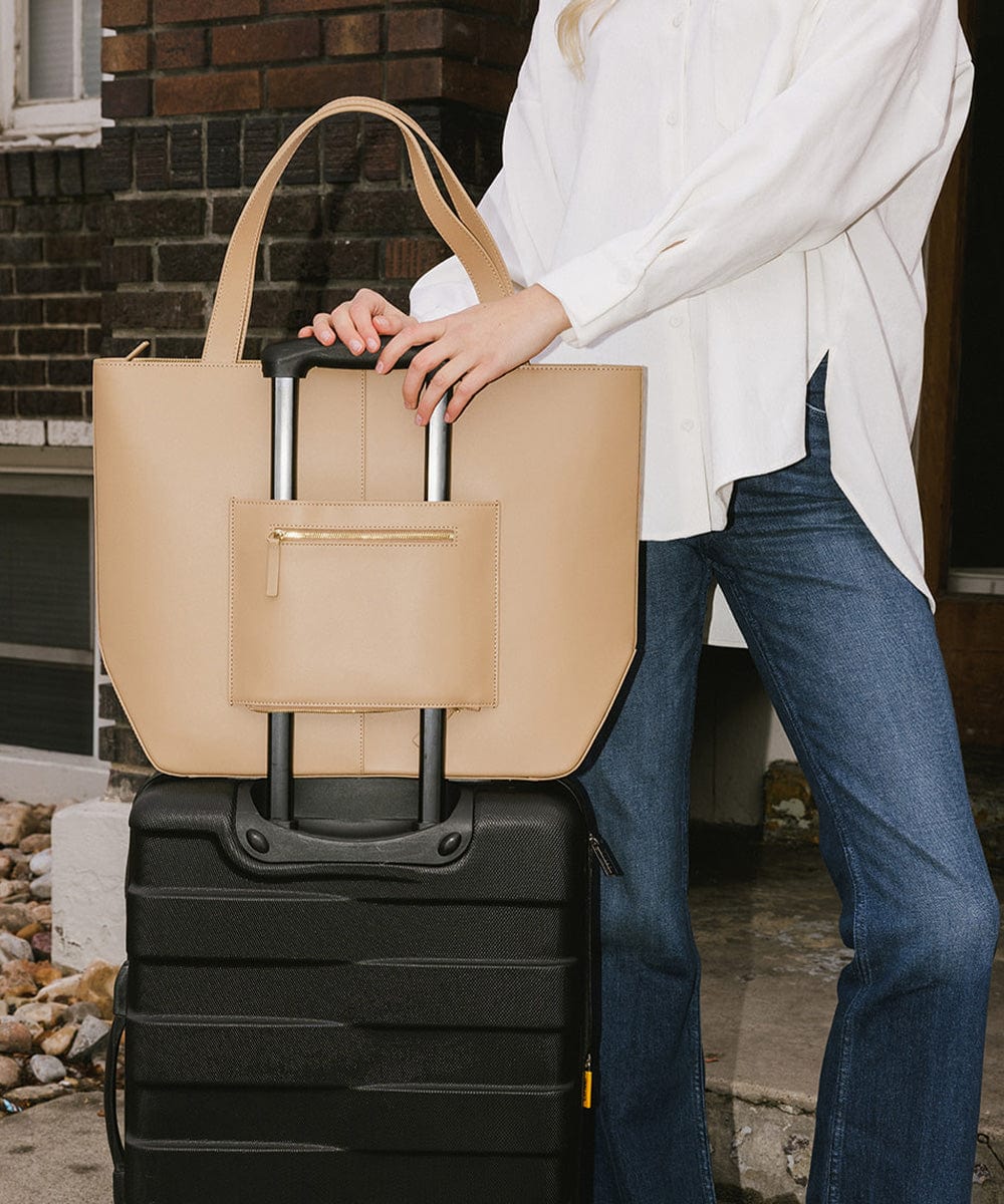Person holding a beige Hayes Hat Carrying Tote bag on a black suitcase #color_tan