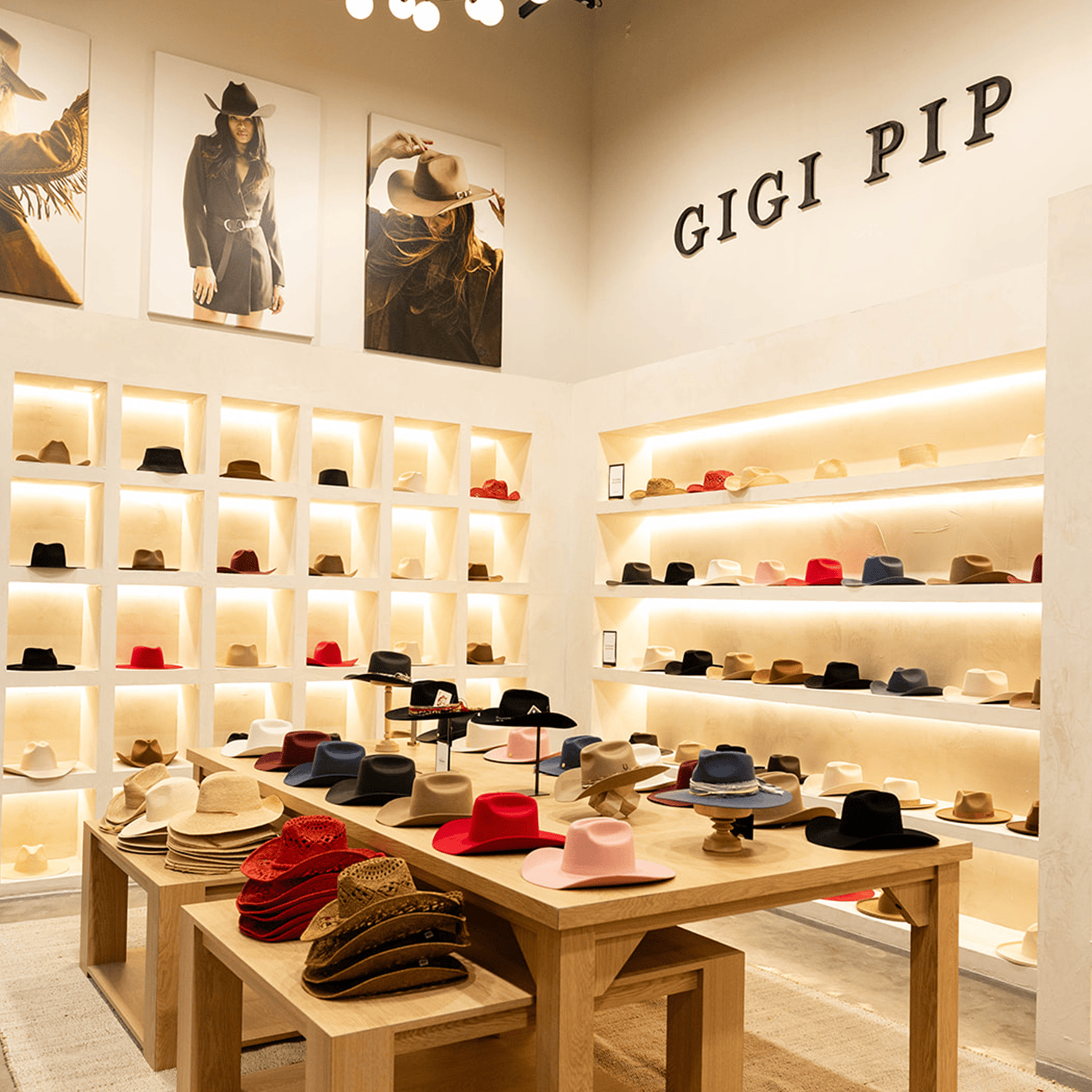 Hat store in Nashville with Gigi Pip branding and various hats displayed on shelves and tables.