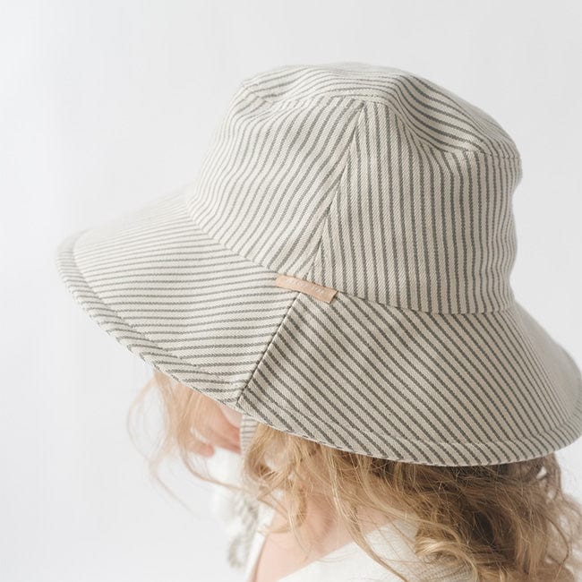 Close up image of someone wearing a grey striped bucket hat against a plain background #color_grey