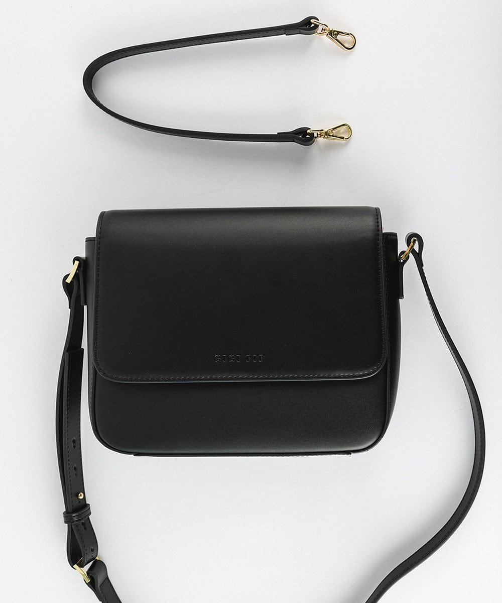 A black Rhys Crossbody Genuine Leather Bag with a detachable strap, displayed against a plain background. #color_black