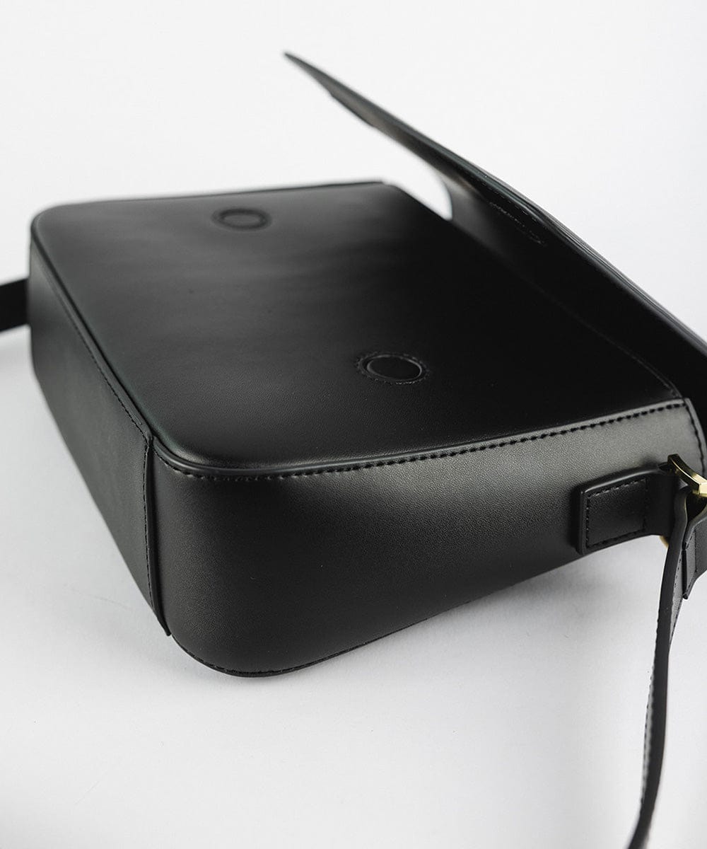 A black Rhys Crossbody Genuine Leather Bag on a plain background #color_black