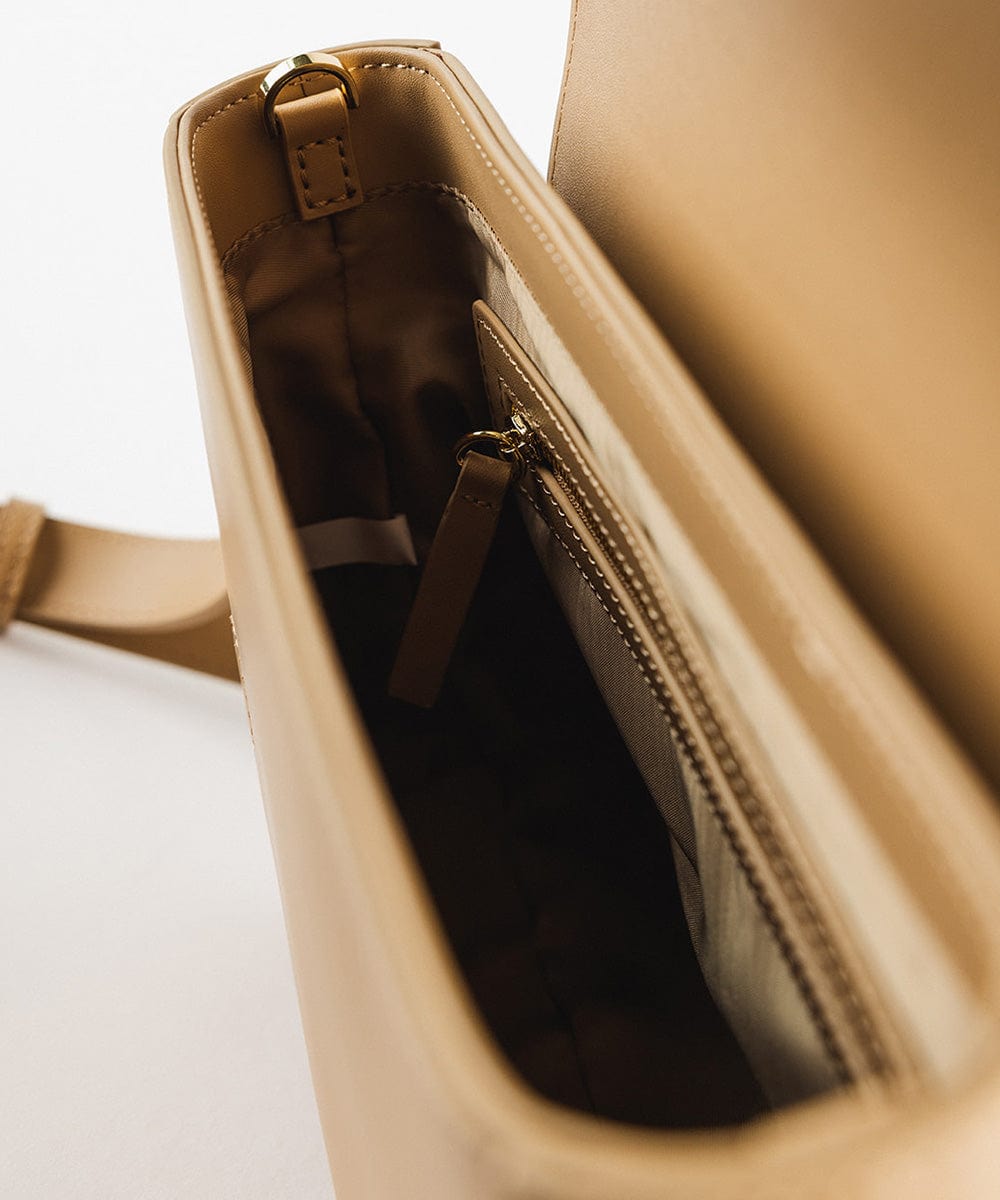 The inside of a tan Rhys Crossbody Genuine Leather Bag on a plain background #color_tan