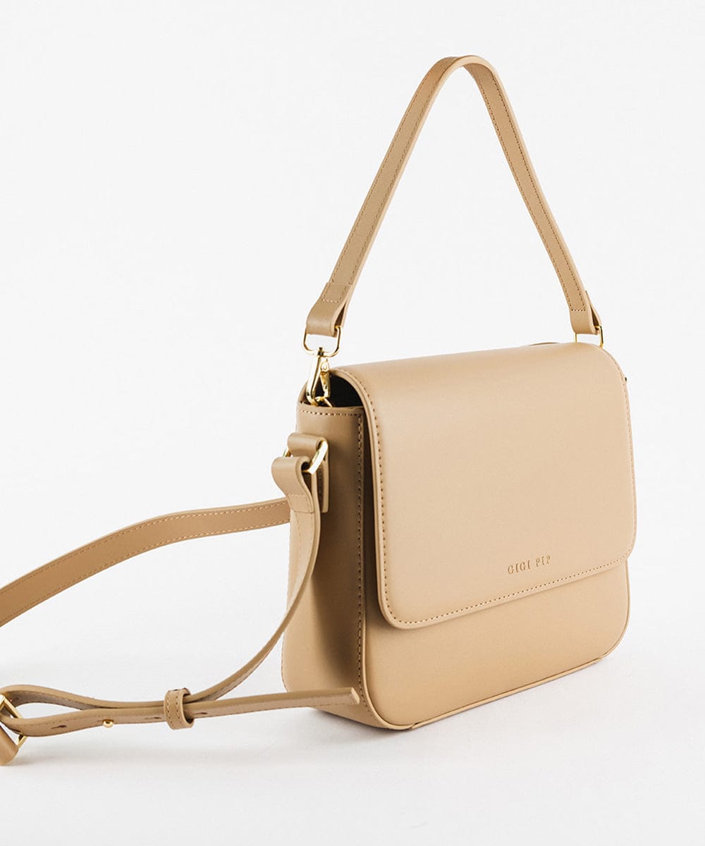 Side angle of a tan Rhys Crossbody Genuine Leather Bag with a detachable strap, displayed against a plain background. #color_tan