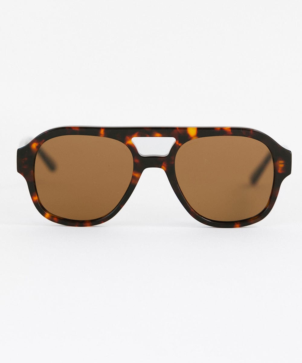 A pair of retro aviator sunglasses with an oversized frame and lighter lenses, featuring a patterned design of a tortoiseshell color. #color_tortoise