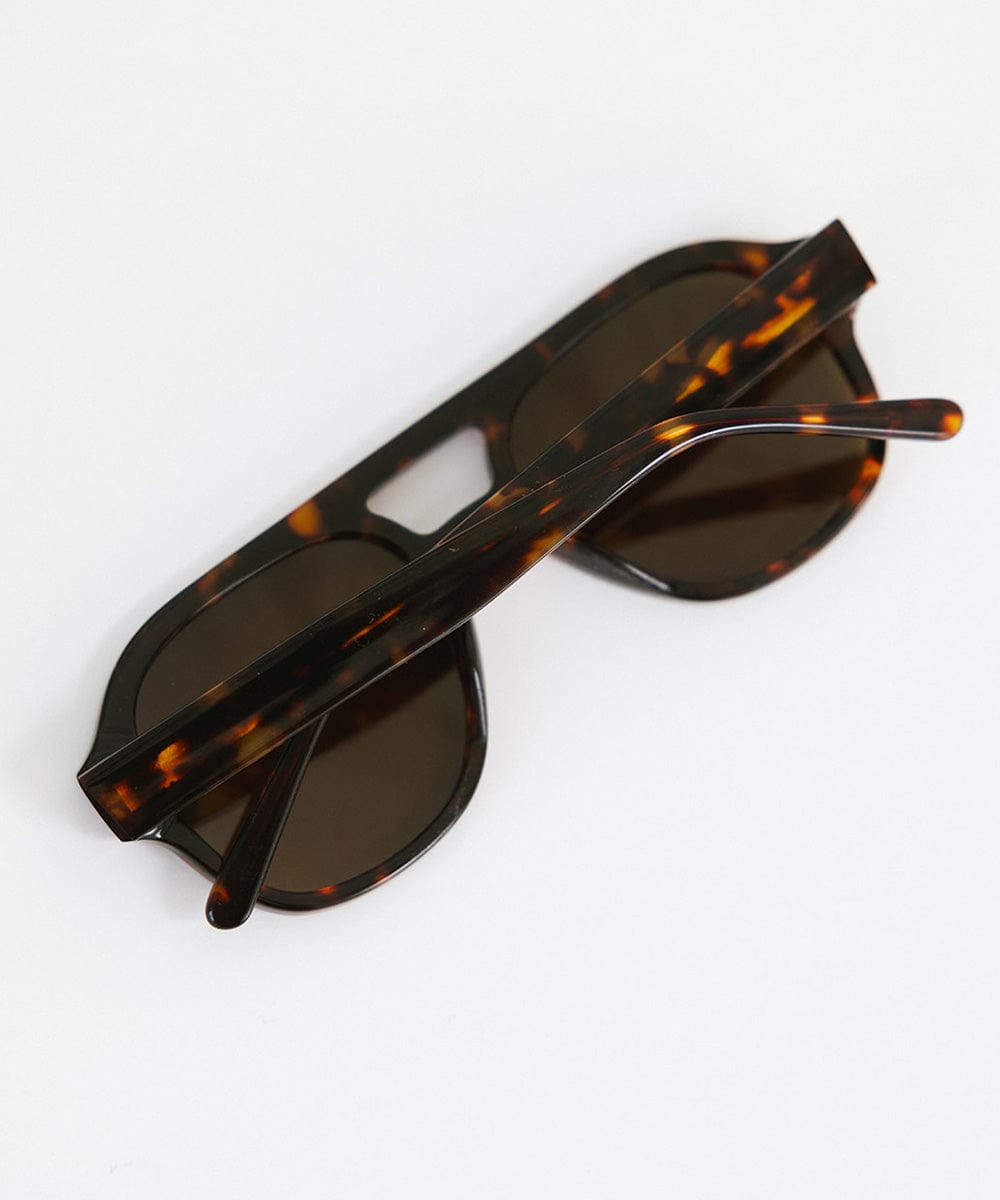 A pair of retro aviator sunglasses with an oversized frame and lighter lenses, featuring a patterned design of a tortoiseshell color. #color_tortoise