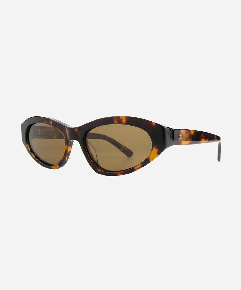 Tortoise colored cat eye sunglasses on a white background #color_tortoise