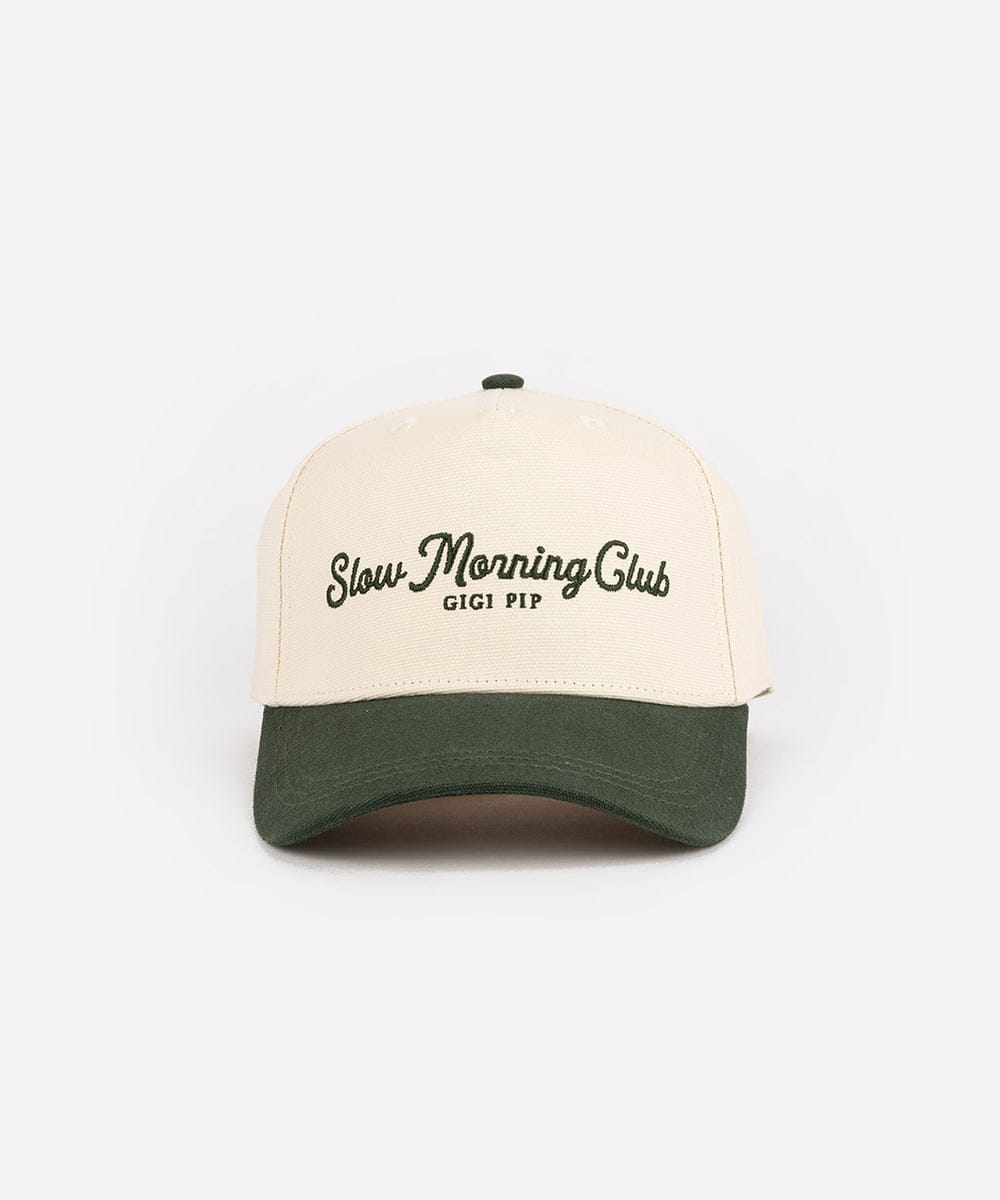 A two-toned cream and dark green cap with 'Slow Morning Club' text on a white background #color_cream - dark green