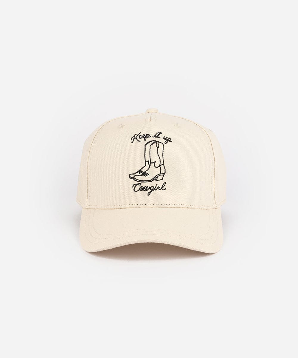 Beige cap with black boot graphic and 'Keep it up Cowgirl' text on a white background #color_cream